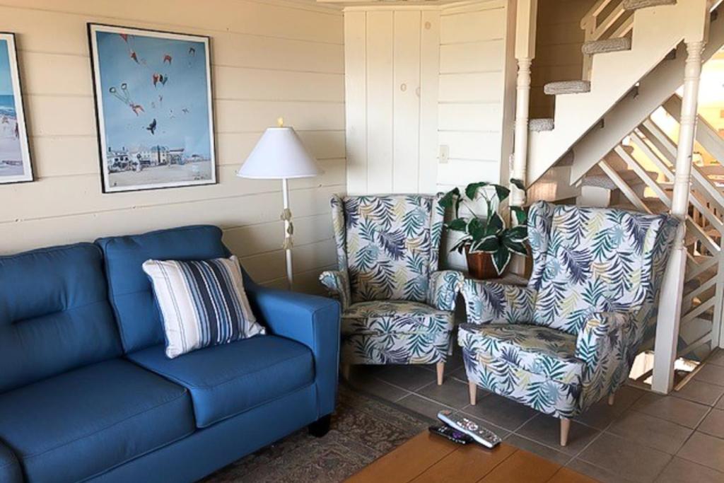 a living room with a blue couch and a chair at Sea Splash 2 in Ocean City
