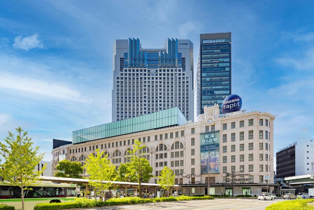 
a city street with tall buildings and tall buildings at Swissotel Nankai Osaka in Osaka
