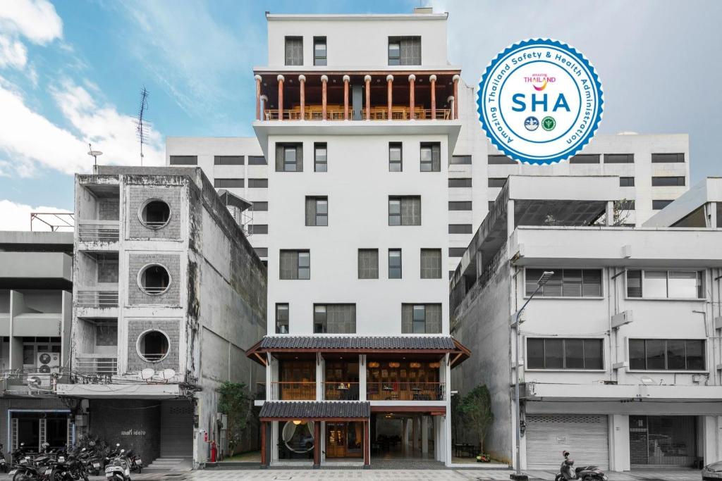 a large white building with a sign on top of it at The Lantern Hatyai Hotel in Hat Yai