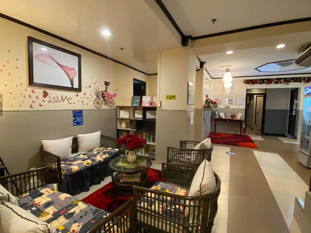 a large living room with couches and a table at Amax Inn Makati in Manila