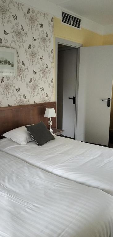 Postel nebo postele na pokoji v ubytování Hotel Le Rivage