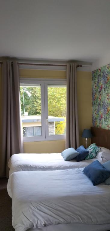 Postel nebo postele na pokoji v ubytování Hotel Le Rivage
