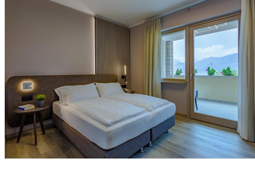 Postel nebo postele na pokoji v ubytování Hotel Veronesi