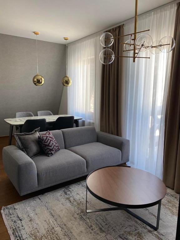 a living room with a couch and a table at Nivalis Residence Jahorina in Jahorina