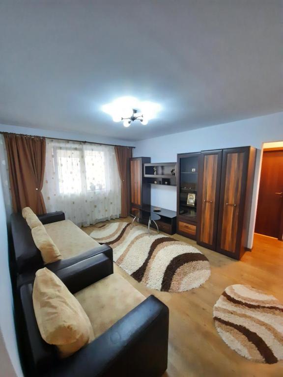 a living room with a couch and a rug at Happy apartament in Sibiu