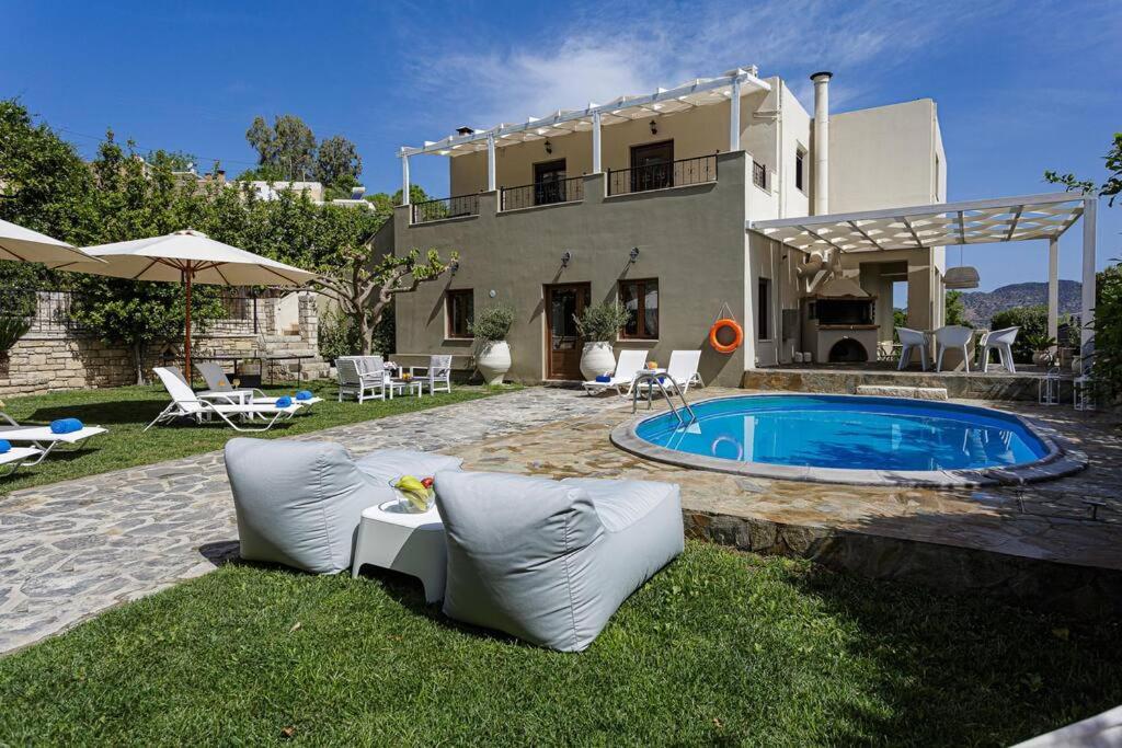 a house with a swimming pool in the yard at Villa Elodia with Pool & Garden in Heart of Crete in Avdhellás