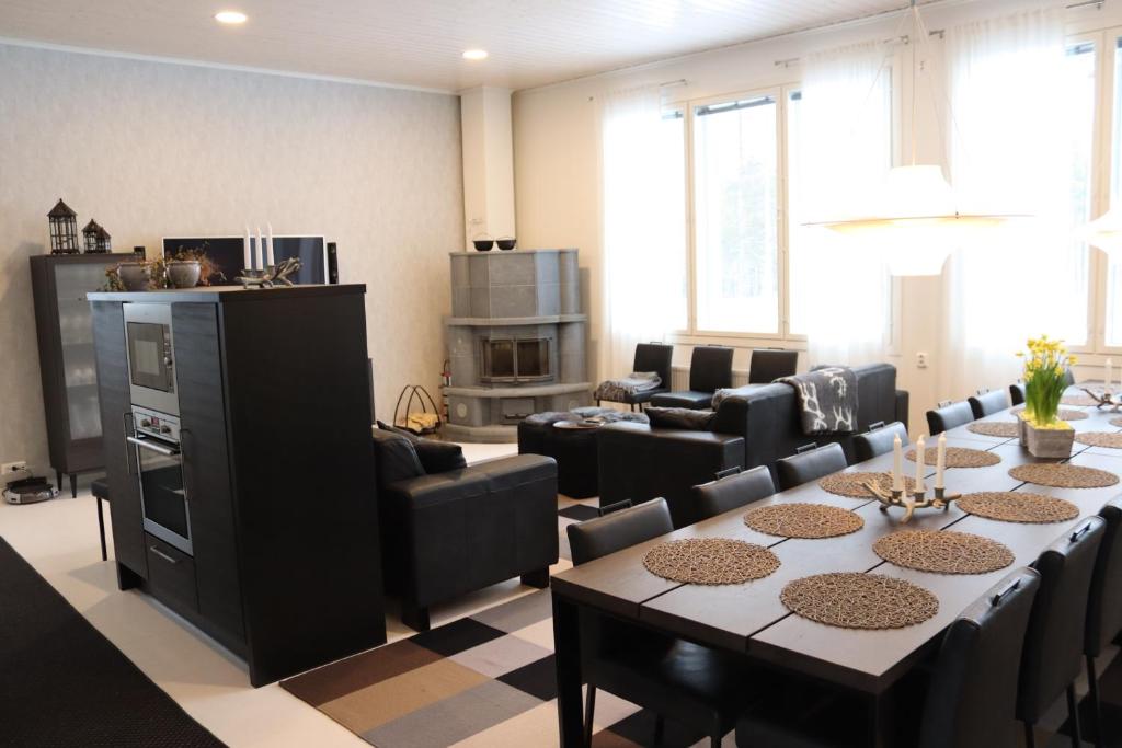 a large living room with a table and chairs at Ruva Holidays in Kuusamo