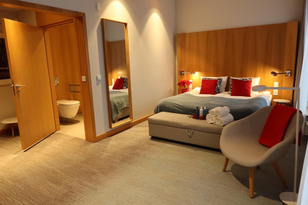 a hotel room with a bed and a mirror at Apartamenty Muzeum II Wojny Światowej in Gdańsk