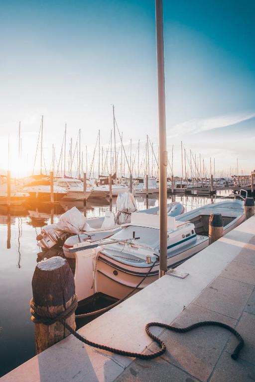 a group of boats docked in a marina at Mosella Suite Hotel in Sottomarina