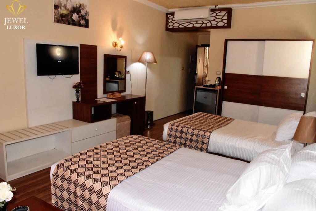 Postel nebo postele na pokoji v ubytování Jewel Luxor Hotel