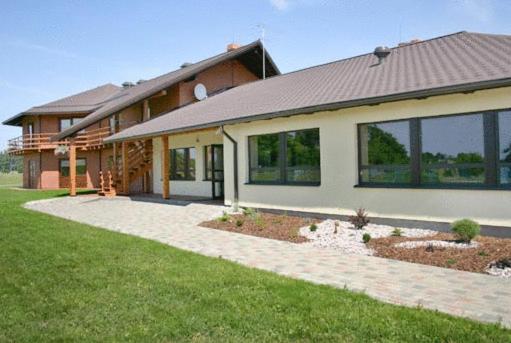 a large house with a lawn in front of it at Liedags Guesthouse in Jūrkalne