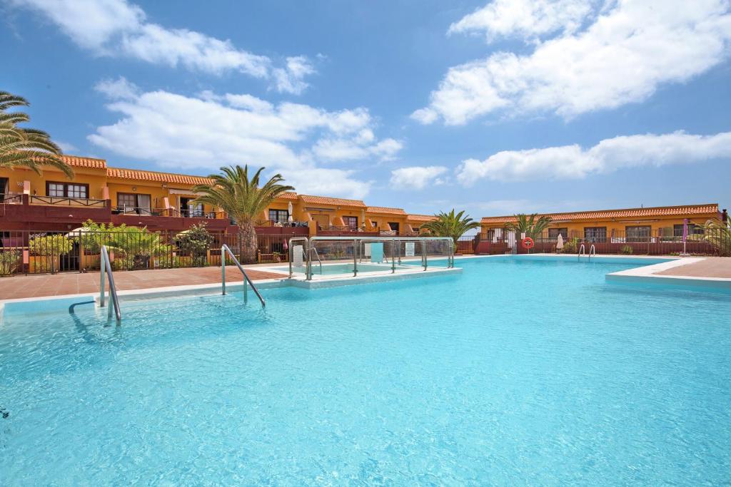 a large swimming pool in front of a building at Casa Anpi in Costa de Antigua
