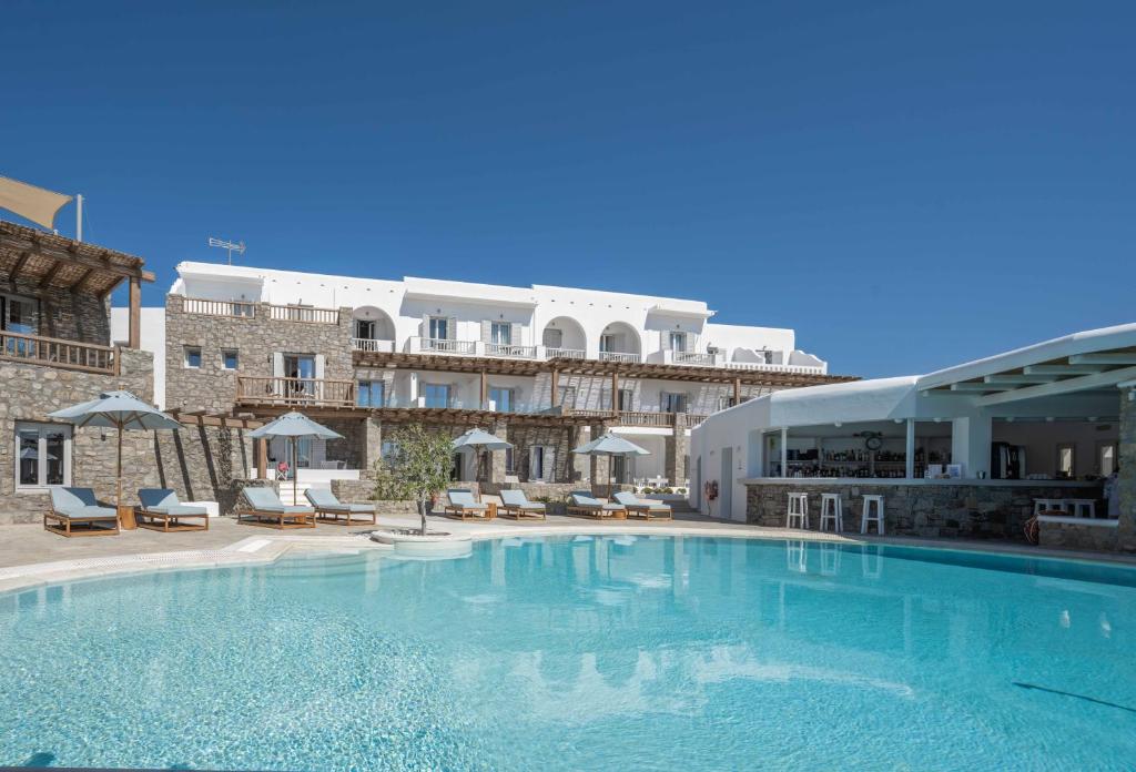 a large swimming pool in front of a hotel at Argo Hotel in Platis Gialos