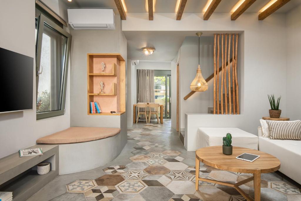 a living room with a couch and a table at Villas Plumeria in Palaiochóra