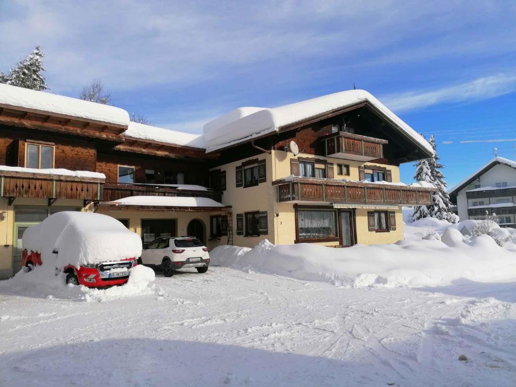 a snow covered house with a car in front of it at Immenstadt im Allgau Holiday Home 2 in Zaumberg