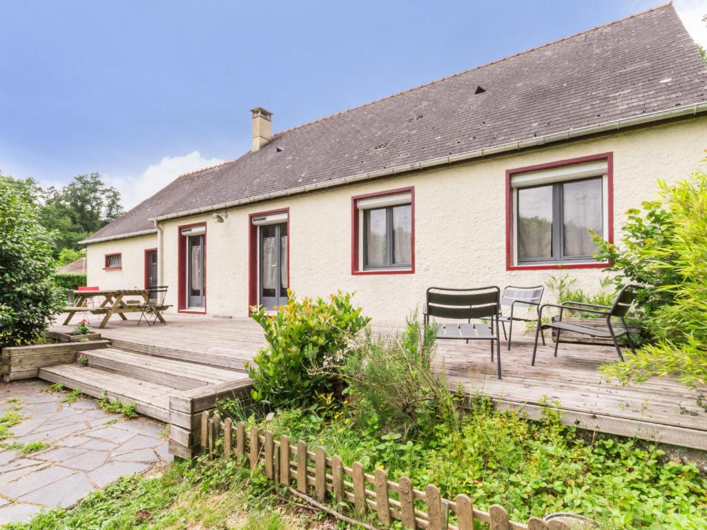 a house with a wooden deck and a patio at Gîte Malville, 5 pièces, 8 personnes - FR-1-306-1153 in Malville