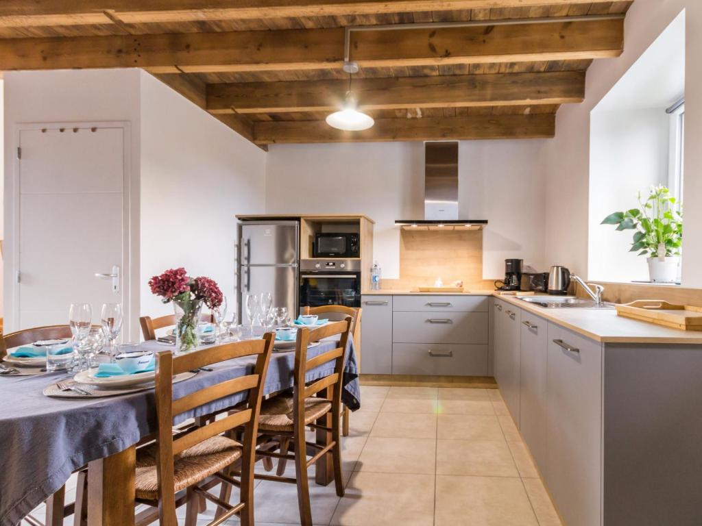 a kitchen with a long table and chairs in a kitchen at Gîte Guérande, 3 pièces, 5 personnes - FR-1-306-1197 in Guérande