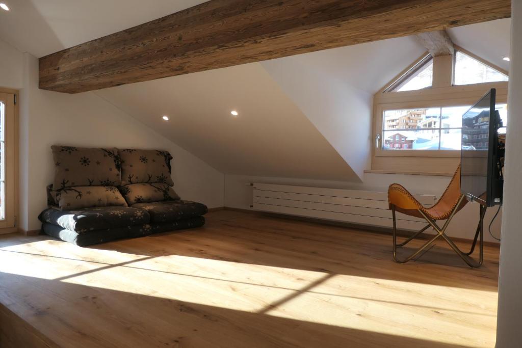 a living room with a couch and a window at Chalet Valeria in Saas-Fee