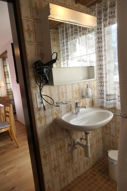 a bathroom with a sink and a mirror at Chalet Valeria in Saas-Fee