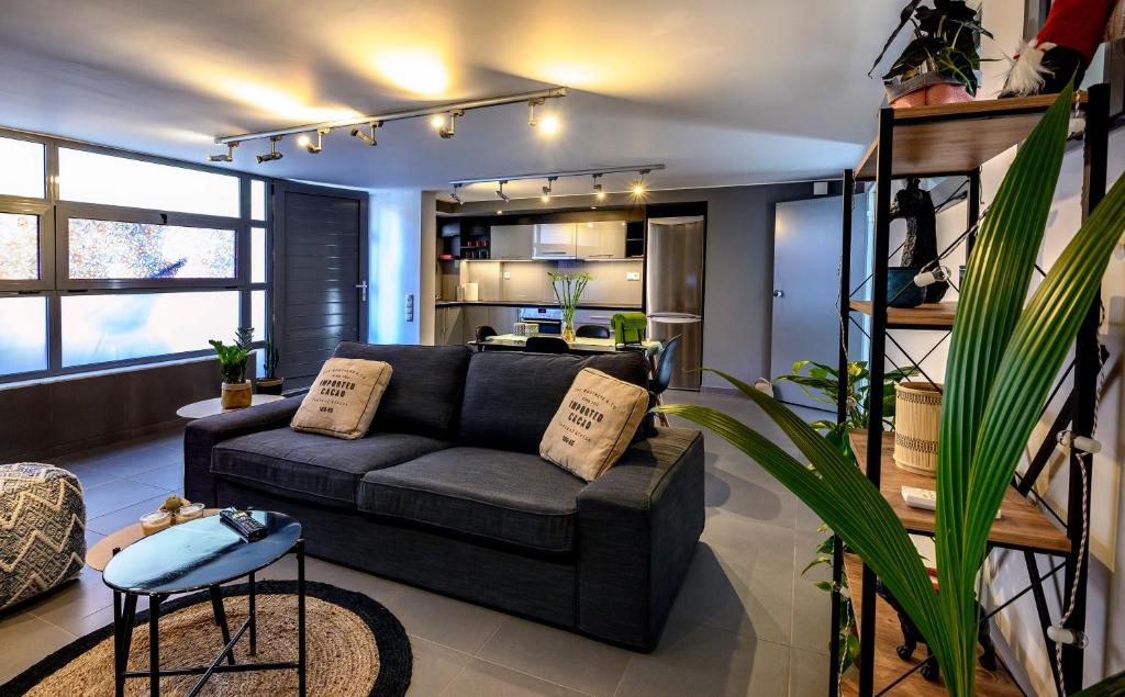 a living room with a couch and a kitchen at Gazi Urban Residence in Athens