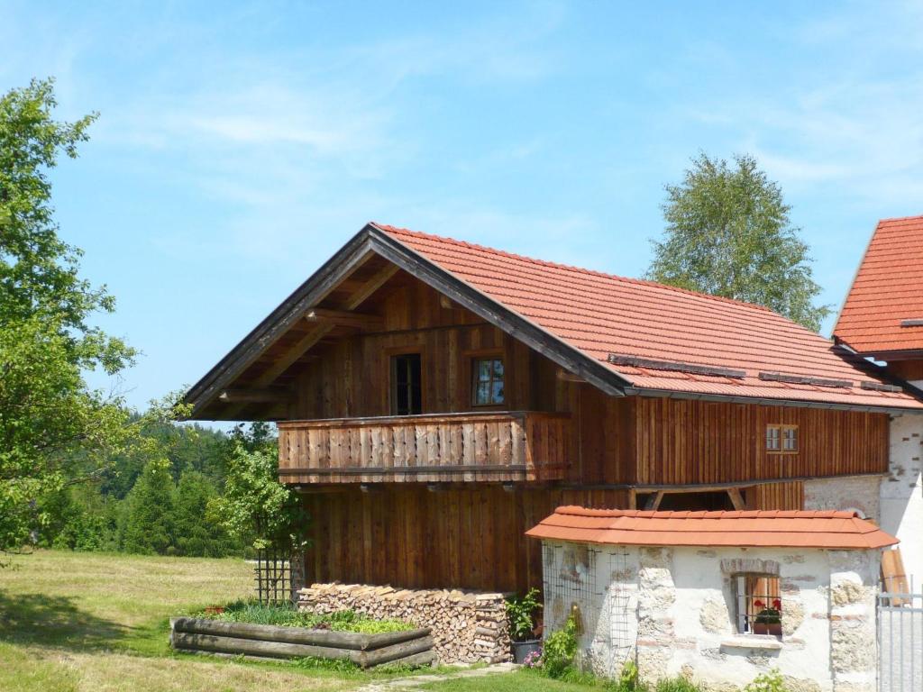 a wooden house with a red roof at Holiday Home Lehner im Wald - RZM100 by Interhome in Rutzenmoos