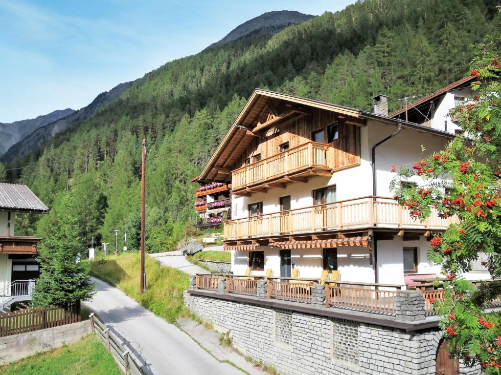 a building with a balcony and a mountain at Holiday Home Kleewein - SOE215 by Interhome in Sölden