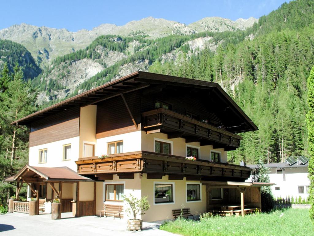 a large building with mountains in the background at Holiday Home Waldhof - SOE685 by Interhome in Im Brand