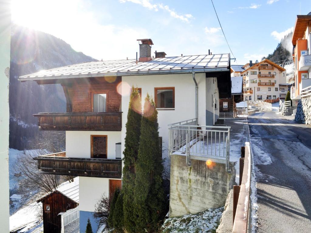 a house on the side of a street with snow at Apartment Miramonte-2 by Interhome in Kappl