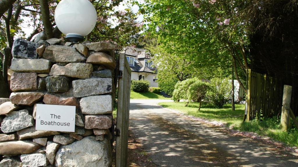 a stone wall with a sign that reads the bibliography at Boat House in Aberdeen