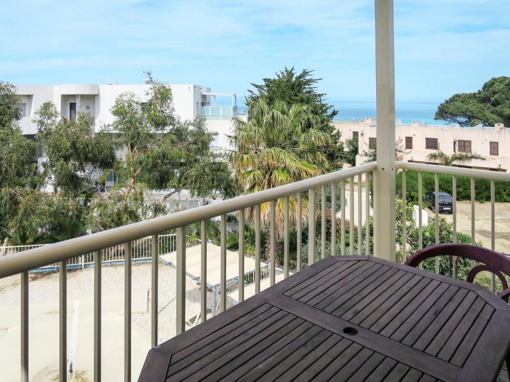 un balcone con tavolo e vista sulla spiaggia di Apartment Résidence Posidonie Hollywood by Interhome a LʼÎle-Rousse