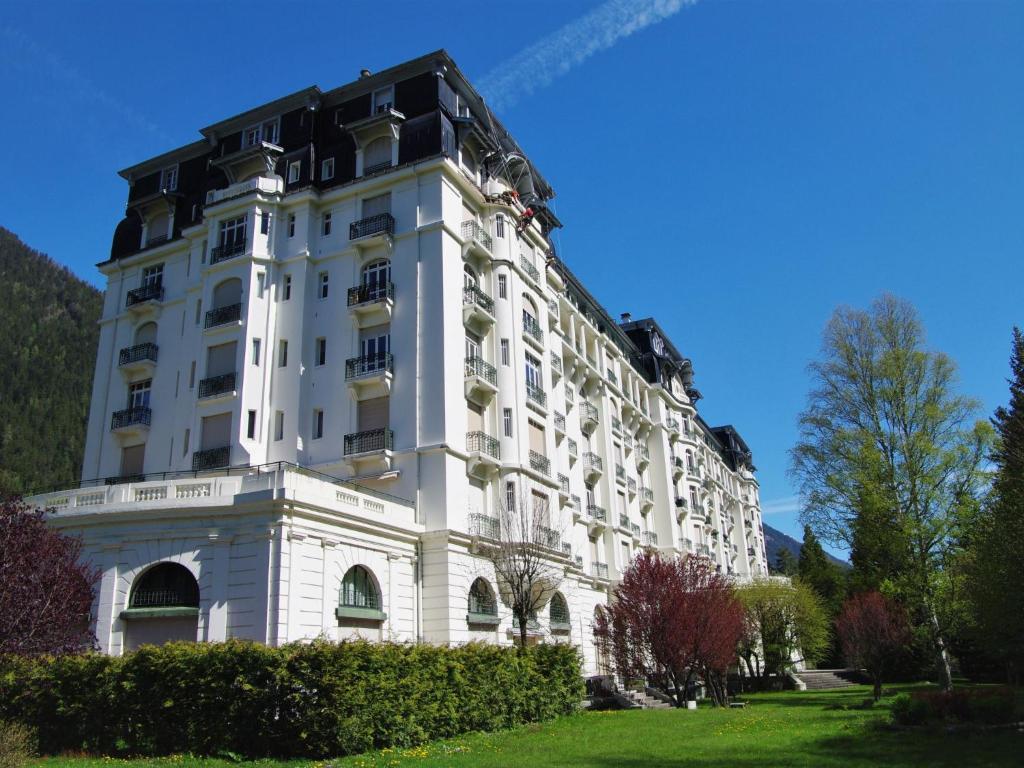 a white building with a black roof at Apartment Le Majestic by Interhome in Chamonix