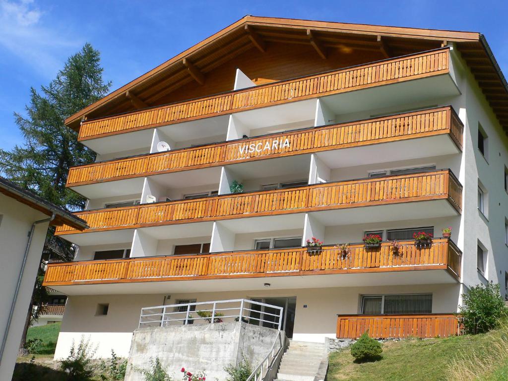 a building with wooden balconies on top of it at Apartment Viscaria-1 by Interhome in Zermatt