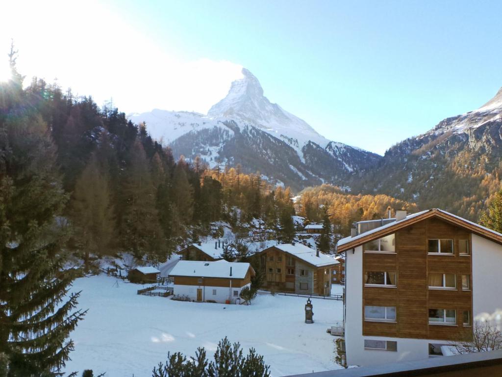 a ski lodge with a mountain in the background at Apartment Obri Tuftra-4 by Interhome in Zermatt
