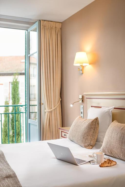 Postel nebo postele na pokoji v ubytování Hôtel Spa Thermalia