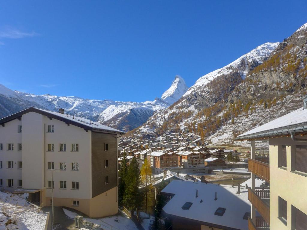 Blick auf eine Stadt mit schneebedeckten Bergen in der Unterkunft Apartment Viscaria-2 by Interhome in Zermatt