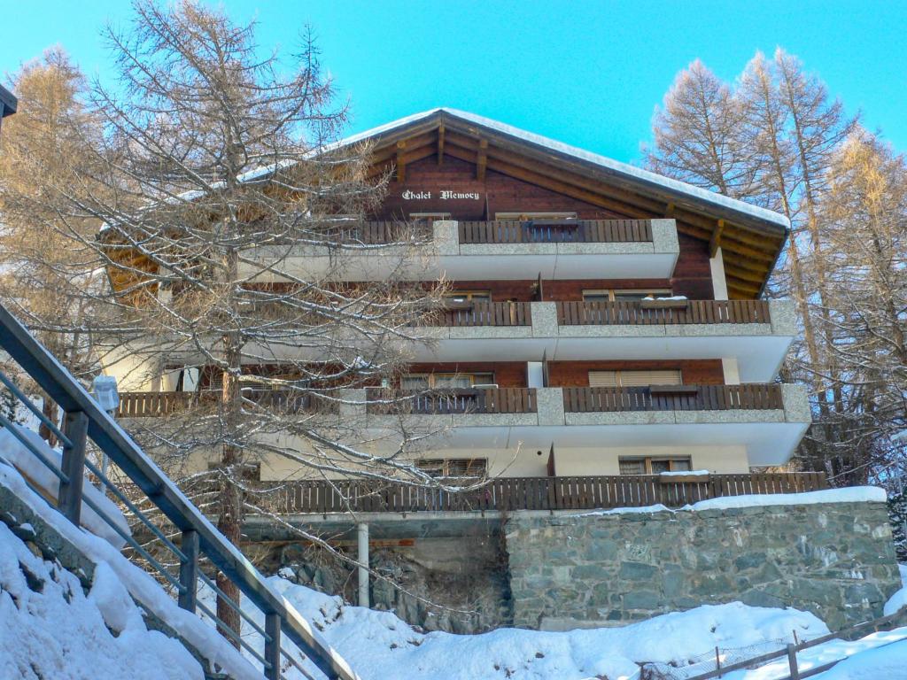 a building in the snow with stairs in front of it at Apartment Memory by Interhome in Zermatt
