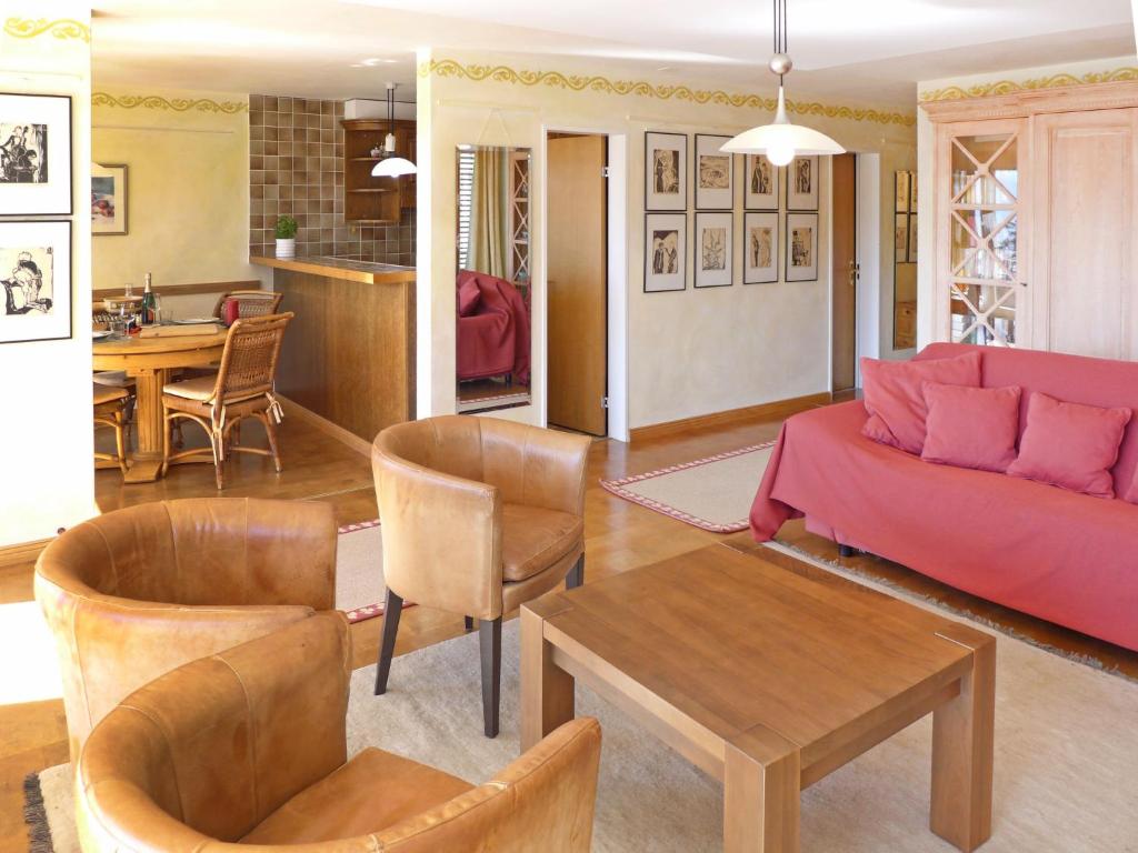 a living room with a couch and a table at Apartment Jeanne D'Arc Apt- H-58 by Interhome in Crans-Montana