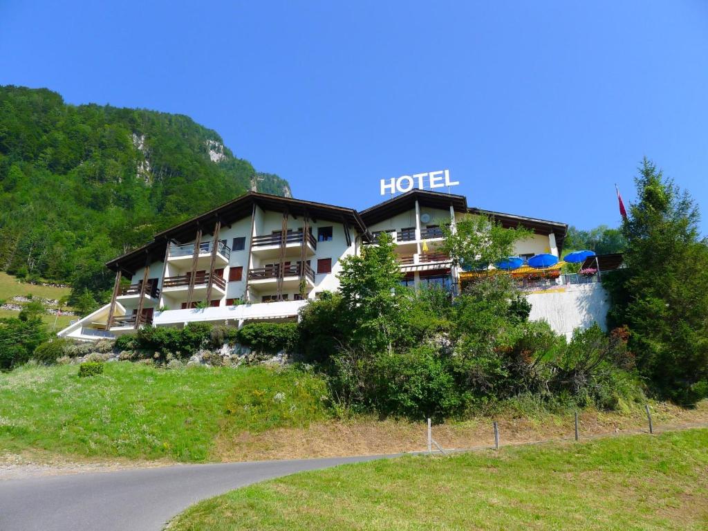 a hotel on a hill next to a road at Apartment Platten by Interhome in Gersau