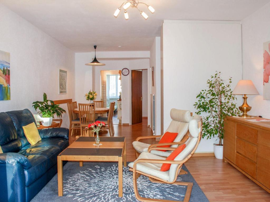een woonkamer met een bank en een tafel bij Apartment Lido App- 46 by Interhome in Locarno