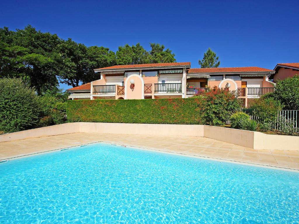 a house with a swimming pool in front of a house at Apartment Le Gallia by Interhome in Capbreton