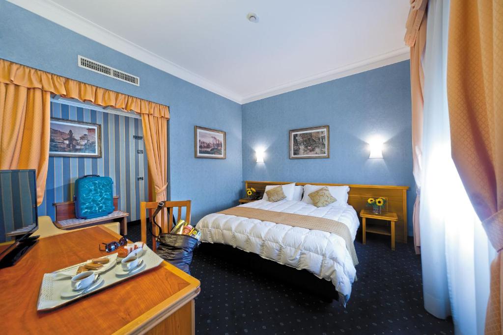 Postel nebo postele na pokoji v ubytování Ele Green Park Hotel Pamphili
