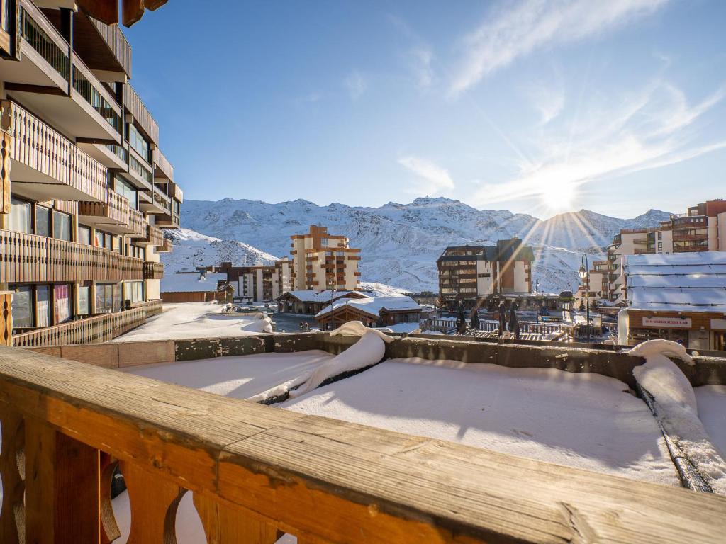 a snow covered hot tub on a balcony with mountains at Apartment Neves-1 by Interhome in Val Thorens