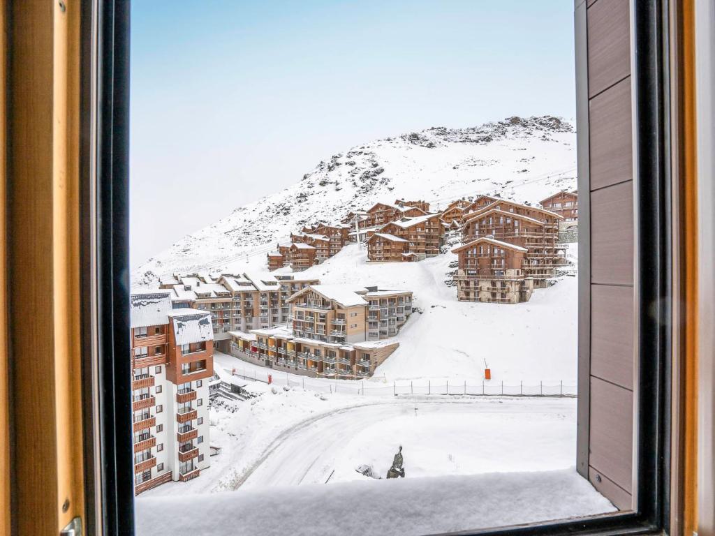 a view of a snow covered mountain from a window at Apartment Arcelle-4 by Interhome in Val Thorens