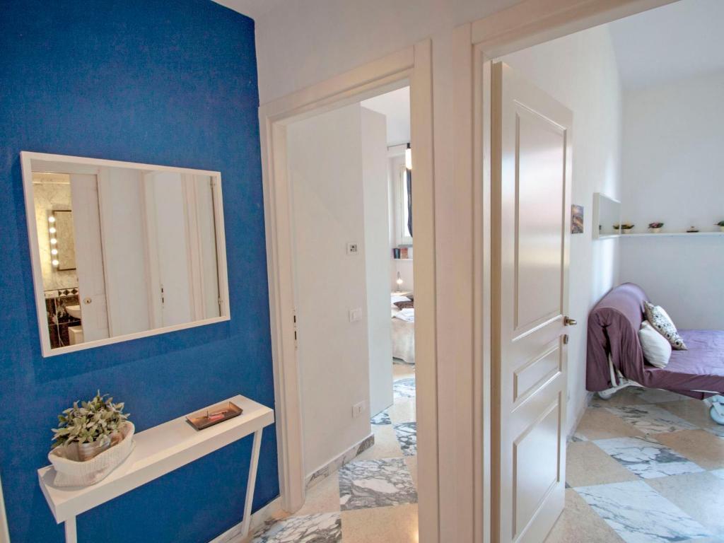 a room with a blue wall and a mirror at Apartment Bufalini 3 - Michelangelo by Interhome in Florence