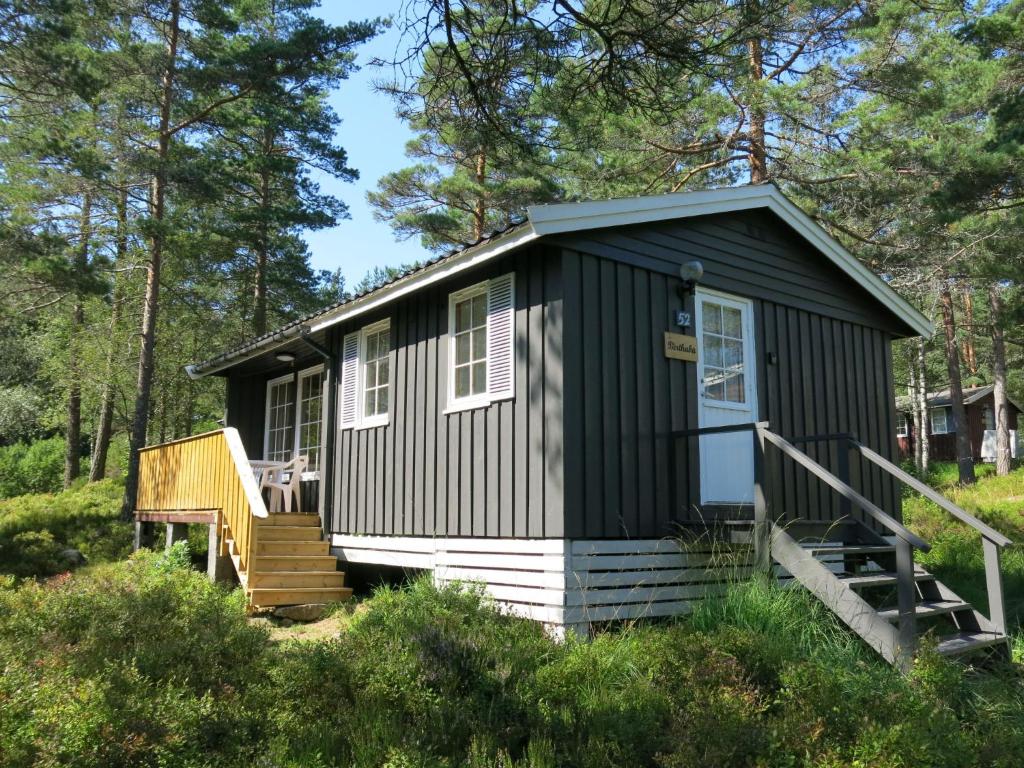 a black tiny house in the woods at Holiday Home Berthabu - SOW116 by Interhome in Øyuvstad