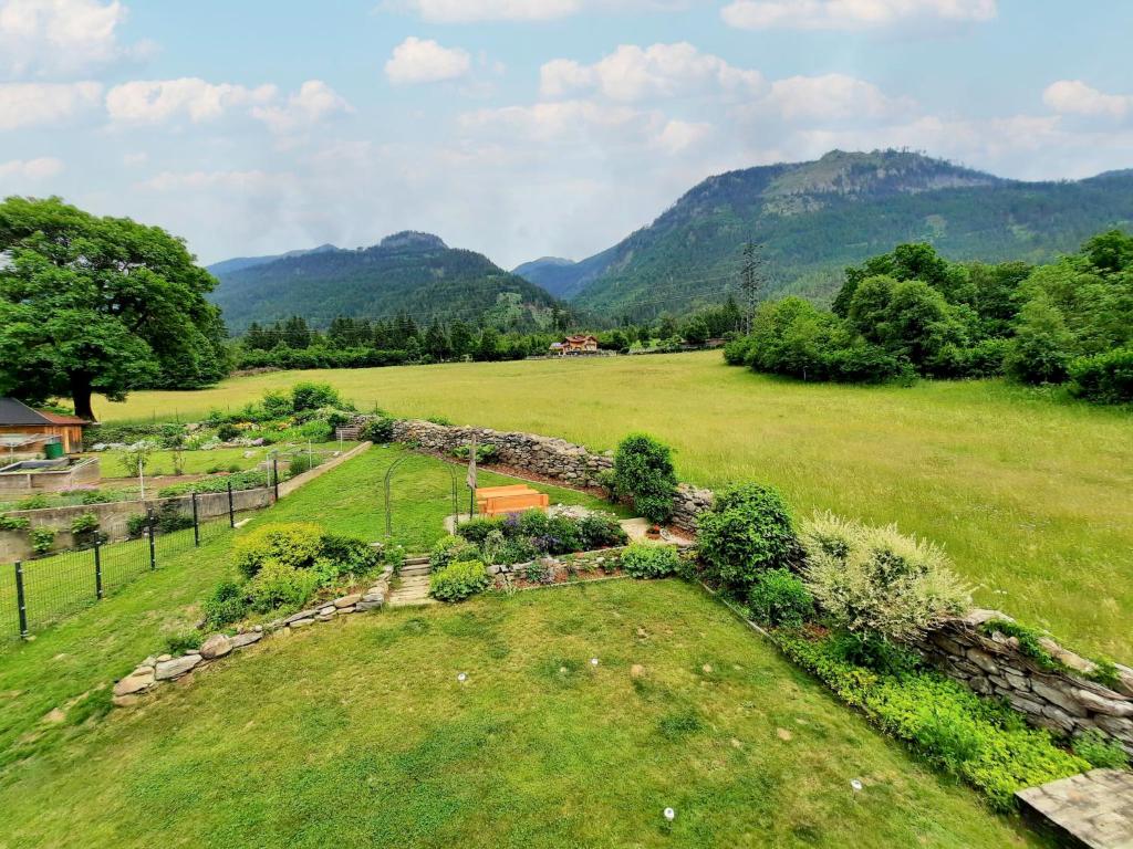 a garden in a field with mountains in the background at Holiday Home Stefanie by Interhome in Mühldorf