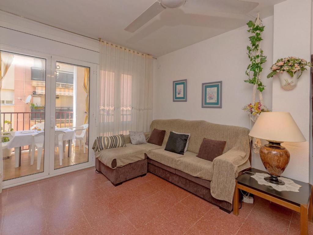 a living room with a couch and a table at Apartment Edificio Garcomar I by Interhome in Segur de Calafell