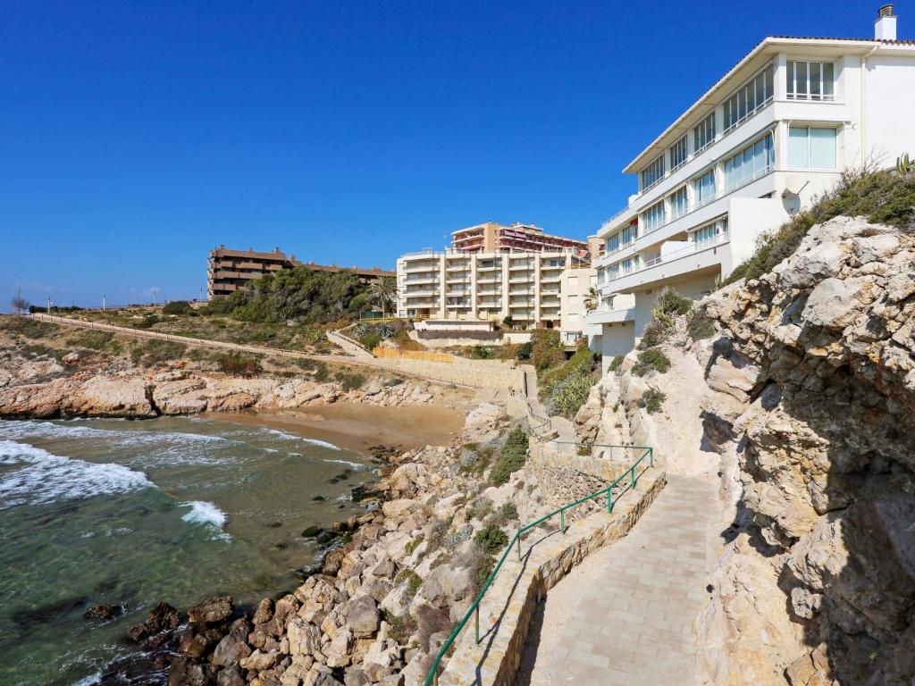a building on a cliff next to a beach at Apartment Rits-1 by Interhome in Salou