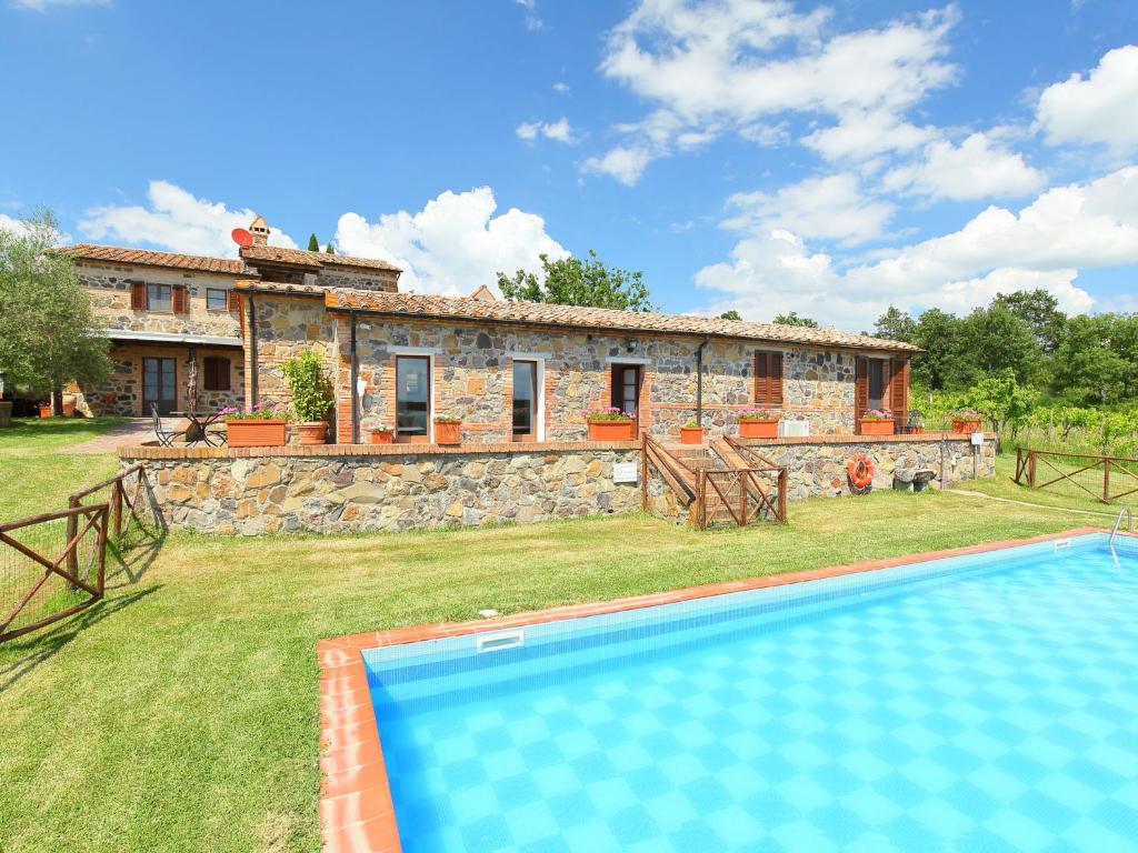 an external view of a stone house with a swimming pool at Holiday Home Val d'Orcia by Interhome in Radicofani