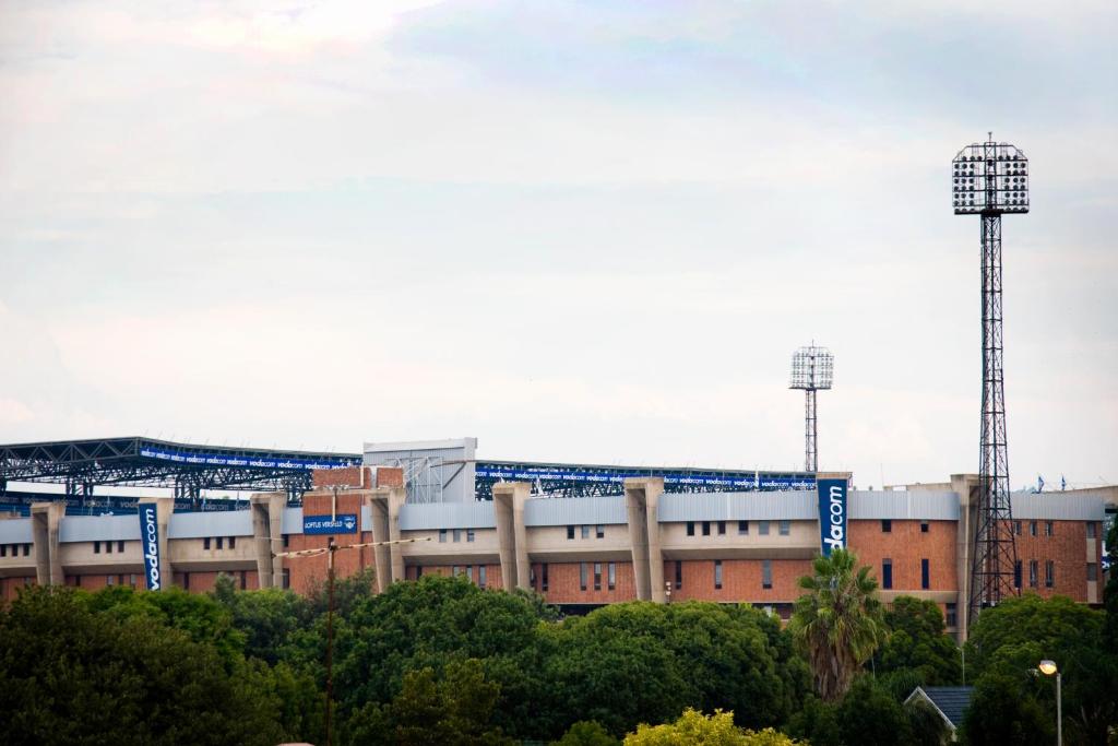 a baseball stadium with two towers in the background at Absolute Farenden Apartments in Pretoria